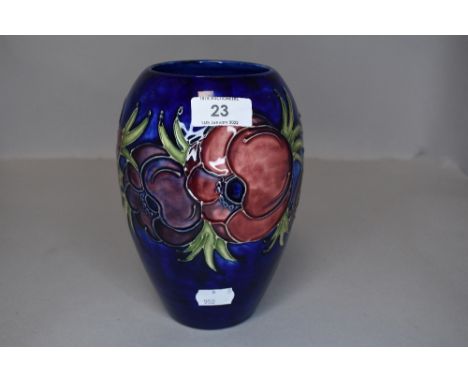 A vintage Moorcroft vase having cobalt blue ground and pattern of anemones.