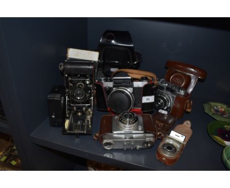 A selection of vintage cameras including Praktika super TL and butchers Watch pocket carbine.