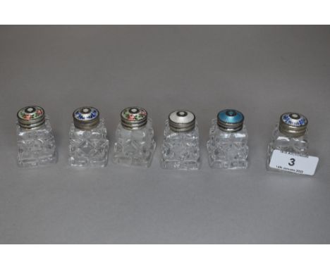 Six vintage cut glass bottles or jars having guilloche lids with floral details.
All six lids testing as HM silver and readin