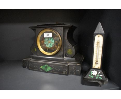 An antique black marble mantel clock having green stone inset details and etched designs, brass window with bevel glass and R