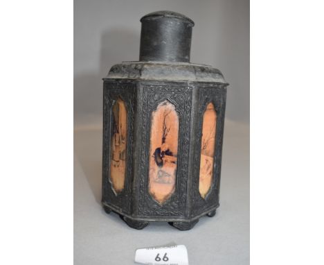 An antique Japanese pewter or spelter tea caddy having pictorial glass inserts to sides.