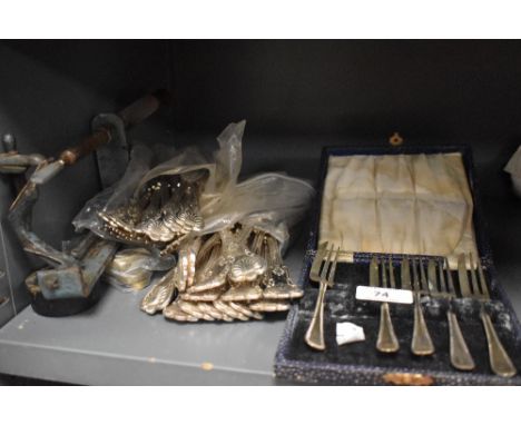 A mixed collection of plated flatware including teaspoons, forks and a vintage apple peeler.