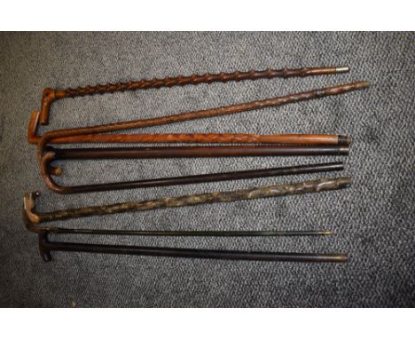 A selection of vintage sticks and walking canes.