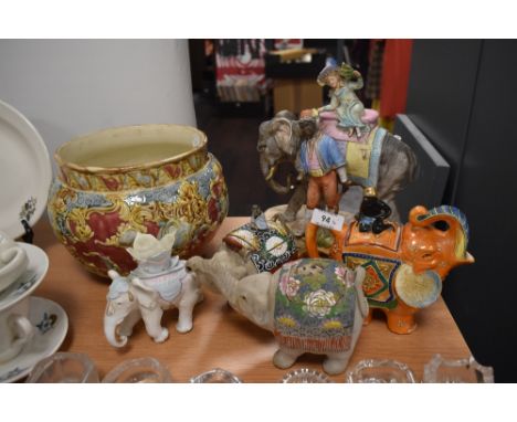 A selection of ceramics amongst which are a planter and elephant ornaments.