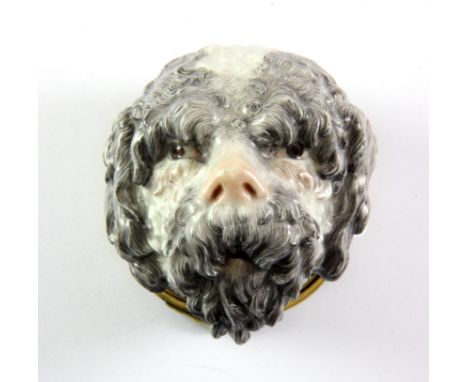 A 19th century gilt mounted porcelain dog's head snuff box, probably Meissen H. 7cm, repair to box cover.