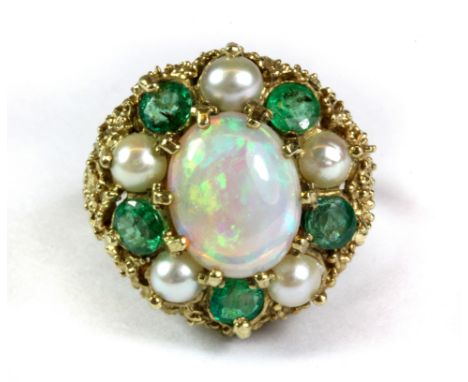 An 18ct yellow gold (stamped 750) opal, emerald and seed pearl set cluster ring, (O.5).