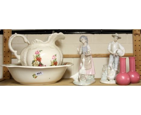 A jug and bowl set with two porcelain figures and a pair of Poole pottery vases.