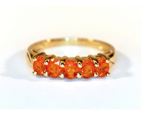 A 9ct yellow gold ring set with five oval cut fire opals, (M.5).