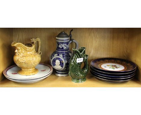 Seven porcelain plates, with a German stein, pottery jug and Goebel jug.