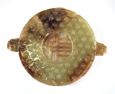 A Chinese archaic form carved jade disc, W. 11cm.