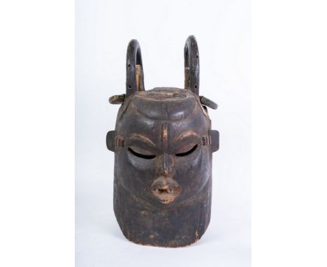African art Two-faced helmet mask, IgboNigeria. . Cm 33,00 x 47,00. Wooden helmet mask with glass, mirror and metal inserts. 