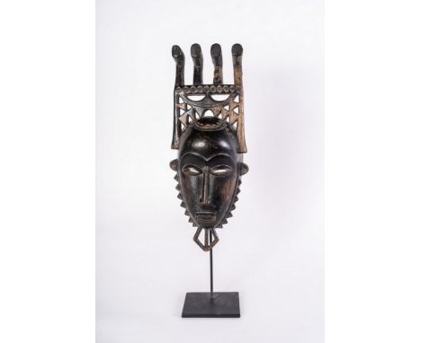 African art Portrait mask, BauleIvory Coast. . Cm 16,00 x 43,00. Black patina wooden mask with four-end headdress. This mask 