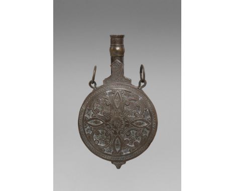 Islamic Art A brass engraved powder flask North Africa or Turkey, 19th century . . Cm 12,50 x 21,00.