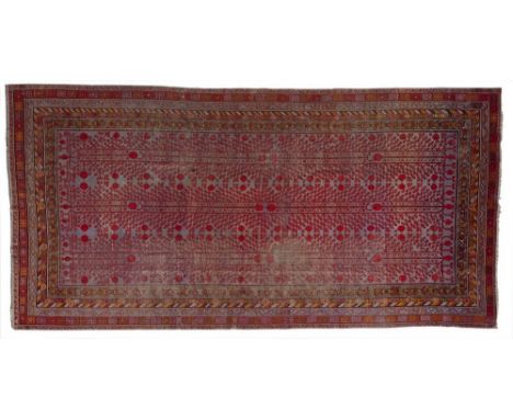Islamic Art A large Khotan Samarkand carpet with pomegranate design Central Asia, first half 20th century . . Cm 272,50 x 555