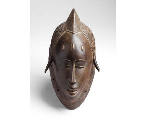 African art Portrait mask mblo, GuruIvory Coast. . Cm 36,00. Red patina wooden dance mask characterized by sharp features and
