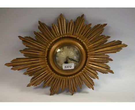 A giltwood wall clock, star ray design