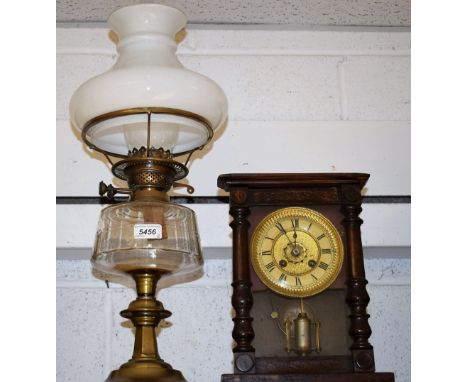 A Victorian brass oil lamp, clear glass reservoir, opaque glass shade, Duplex twin burner; a late 19th century German alarm m