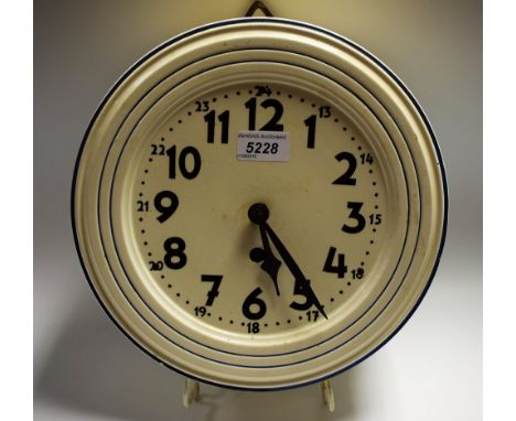 A German pottery kitchen clock, labelled Geschutzt Depose