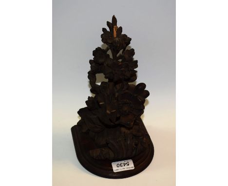 A 19th century wall bracket, formed from an earlier limewood section carved with flowers and leaves, D-shaped plateau, 24cm l
