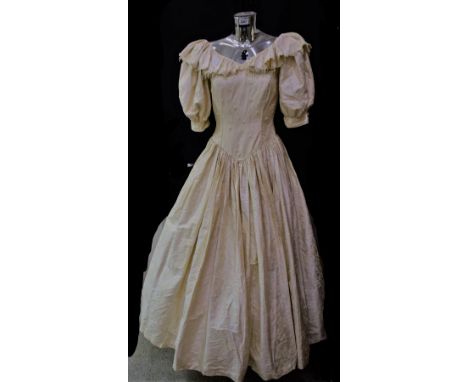 Textiles - a printed cream silk wedding gown, full skirt, net underskirt, fitted button back bodice, embellished with freshwa