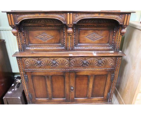 An oak buffet sideboard of Elizabethan design fitted cupboards and drawers, 130cm wide x 136cm high