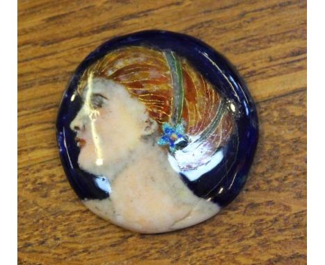 A circular female portrait enamelled plaque