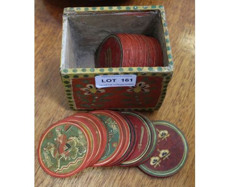 A small hand painted box containing a series of circular Indian hand painted playing tokens, 70 tokens