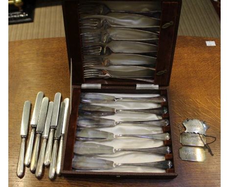 Three HM silver decanter labels with a cased set of fish knives and forks and silver handled fruit knives&nbsp;