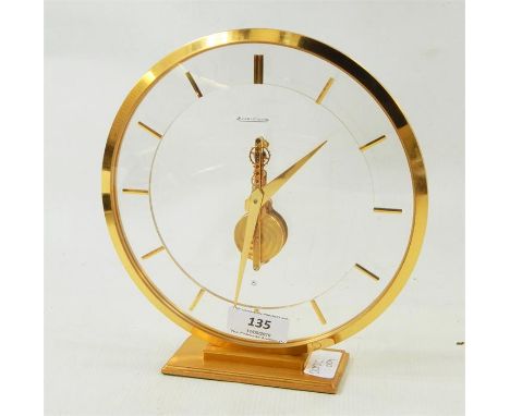 Jaeger Le Coultre modern mantel clock, circular, on a rectangular base, registration number to base 474, 19cm high   