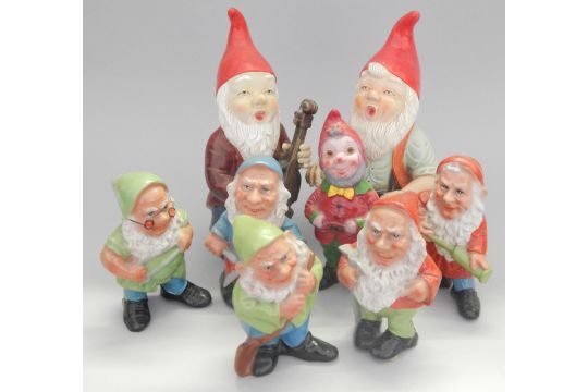 A Group Of Eight Painted Terracotta Garden Gnomes To Include A Musician Dwarf Type Figures Etc