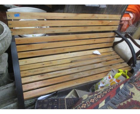 A modern black painted metal and slated wooden garden bench 