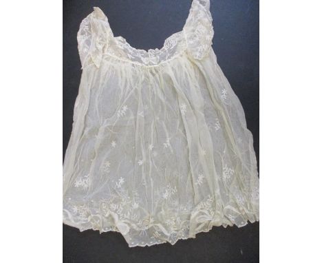 A vintage suitcase containing cotton crocheted and lace adult clothing from the 19th and 20th centuries to include pantaloons