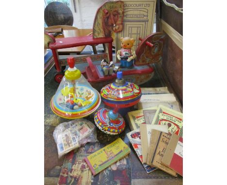 Vintage toys to include two wooden sit on toys, three spinning tops, a mechanical bear, a small Steiff model called 'Clownie'