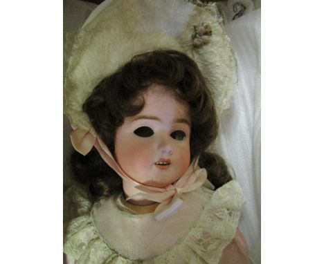 A Schoenau and Hoffmeister bisque headed doll, open mouth showing four teeth, composition jointed body, marks to back of head
