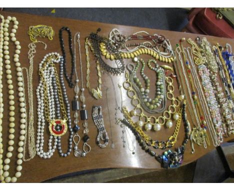 A selection of 20th century jewellery to include an ivory string necklace and seed pear examples and late 20th century costum