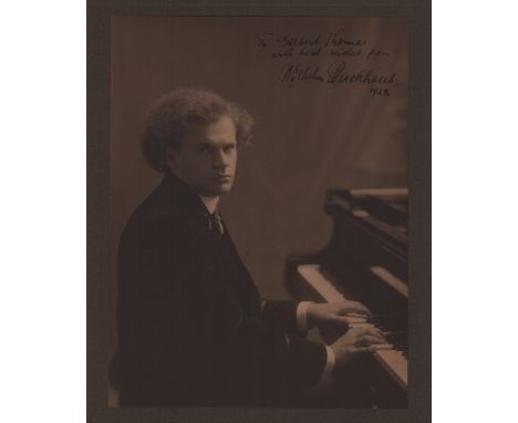 BACKHAUS WILHELM: (1884-1969) German Pianist. A good, large vintage signed sepia 10.5 x 12.5 photograph of Backhaus seated in