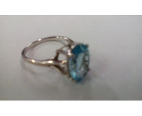 Silver dress ring with large blue gemstone 