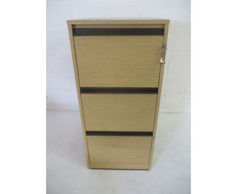 A light oak effect three drawer filing cabinet with key