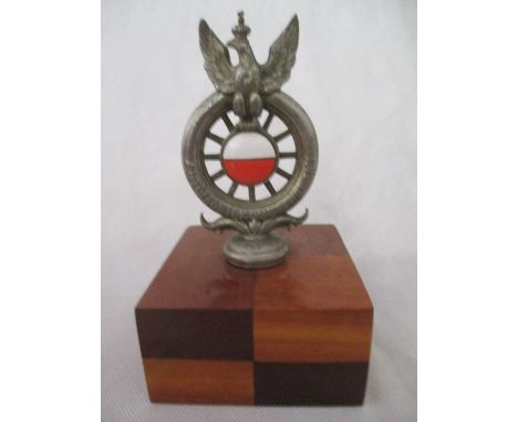 A Polish Automobile Club full-member's motor-car badge, with white and orange enamels to the centre of a spoked wheel, topped