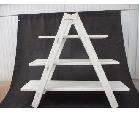 A painted ladder style display unit.