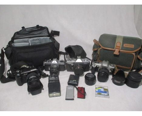 An Olympus E-300 8.0 Megapixel camera along with accessories in carry bag, along with three others camera's including a Canon