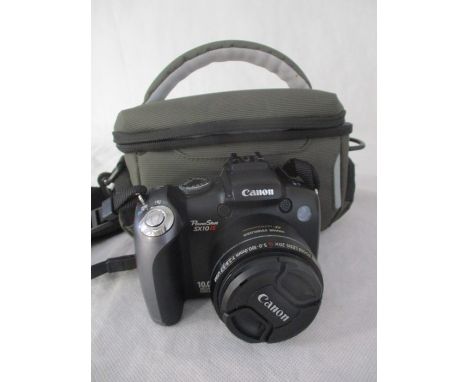 A Canon Power Shot SX10 IS digital camera in case