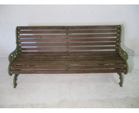 A wooden slatted garden bench with cast iron ends