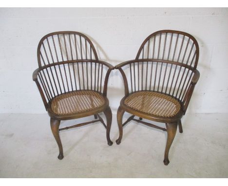 A pair of stick back Windsor carvers with cane seats