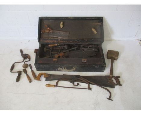 A vintage tools chest with various tools enclosed included saws, wooden mallets etc