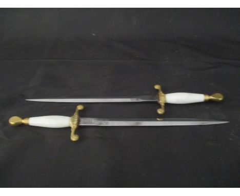 A pair of Wilkinson Sword presentation daggers with gilt mounted handles, overall length 40cm