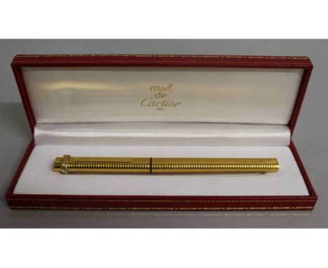 A CARTIER GILT BIRO PEN in original box.