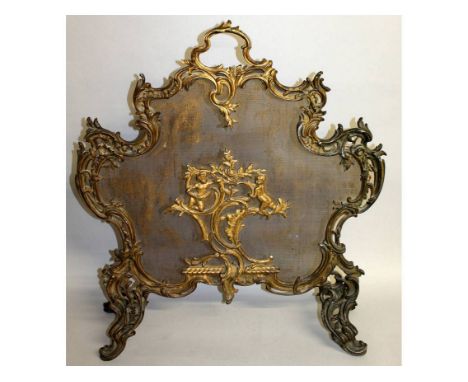 A GOOD LOUIS XVI ORMOLU FIRESCREEN with rush work back, scrolls and cupids. 30ins high.