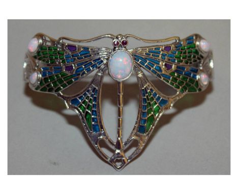 A SILVER PLIQUE DRAGONFLY BANGLE set with opals and emeralds.