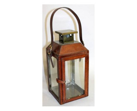 A LEATHER HANGING LANTERN with strap. 1ft 1ins high.